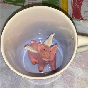 Pottery mug with flying pig.
